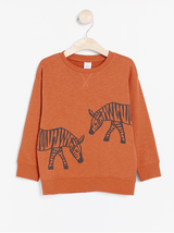 Oversize mørke orange trøje med zebra print