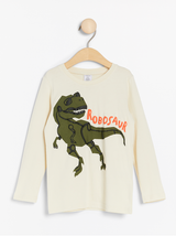 Lys beige bluse med dinosaur print
